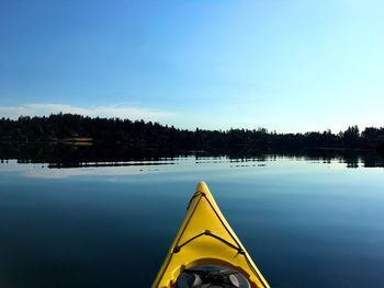 Scenic view of swimming pool by lake against clear blue sky