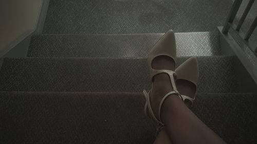 Low section of woman standing on tiled floor