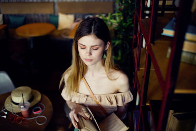 Young woman sitting on chair at table