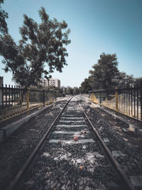 Surface level of railroad tracks against clear sky