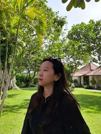 Portrait of beautiful young woman standing in park