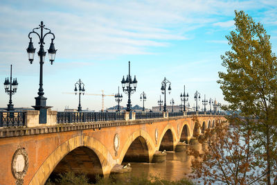 Pont de pierre over garonne river against blue sky