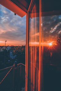 View of building through window during sunset