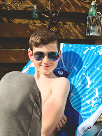 Portrait of young man sitting in swimming pool