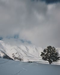 Scenic view of snow covered mountains against sky