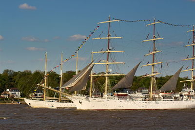 Ships sailing at sea against sky