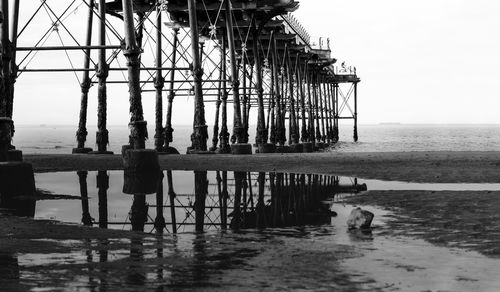 Pier on sea against clear sky