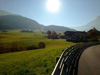 Scenic view of field and mountains against clear sky