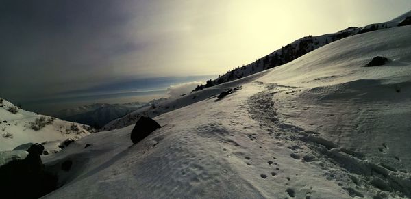 Scenic view of snow mountains against sky