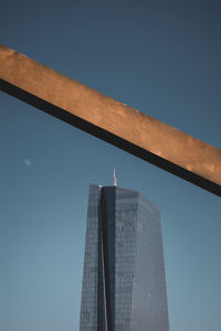 Low angle view of modern building against clear blue sky