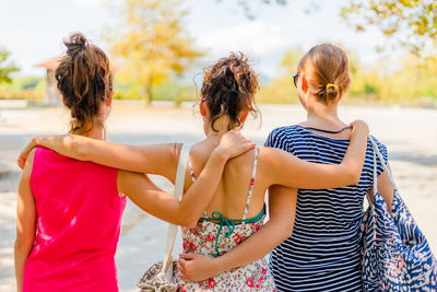 Rear view of mother and daughter outdoors