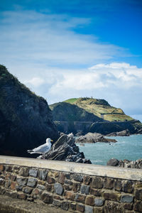 Scenic view of sea and mountains against sky