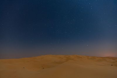 Scenic view of desert against sky at night