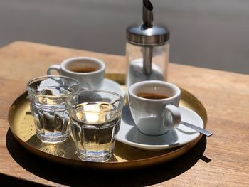 Coffee with drinking glass served on table