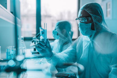 Side view of female scientist working in laboratory