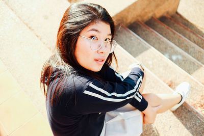 High angle portrait of cute girl standing outdoors