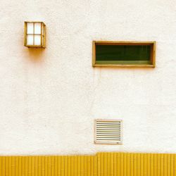 Window and air duct on wall of building