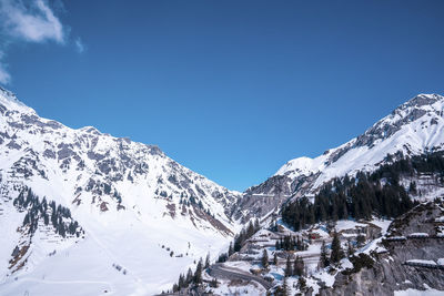 Avalanche barriers on snow covered mountain slope with trees