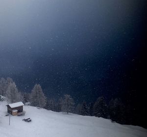 Scenic view of snow against sky at night