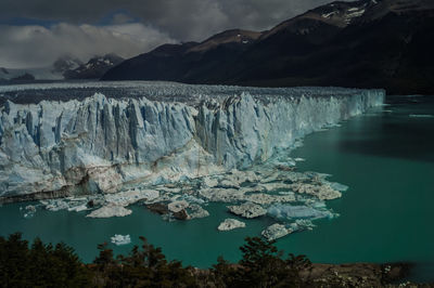 Scenic view of lake against sky during winter