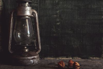 Winter cherries and oil lamp on table 