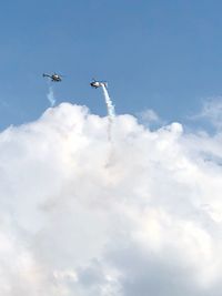 Low angle view of airplane flying against sky