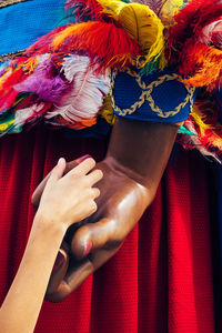 Close-up of hand holding multi colored decoration