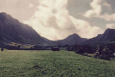 Scenic view of mountains against cloudy sky