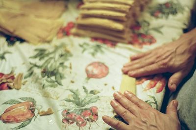 Cropped image of hand holding sweet food