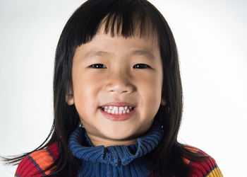 Portrait of smiling boy against white background