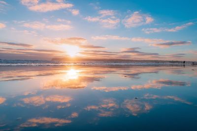 Scenic view of beach against sky during sunset