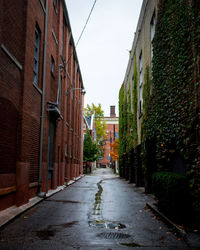 Street amidst buildings in city against sky