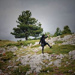 Full length of person on rock against sky