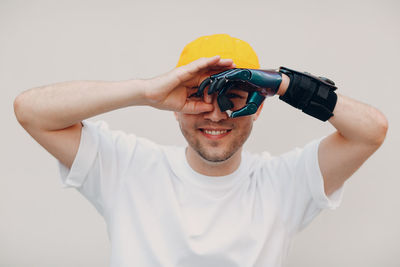 Portrait of young man using smart phone against white background