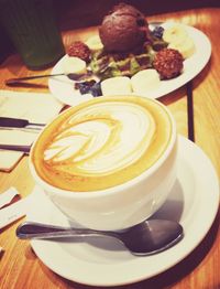 Close-up of cappuccino served on table