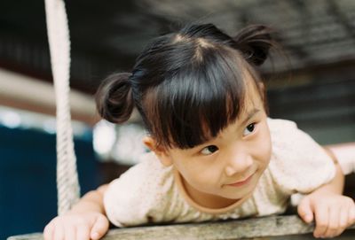 Close-up of thoughtful girl on swing