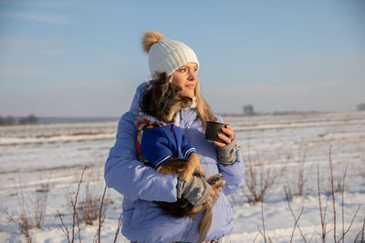 Rear view of woman standing against sky