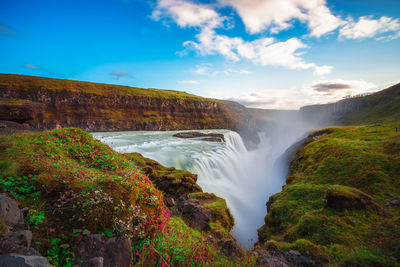 Scenic view of waterfall against sky