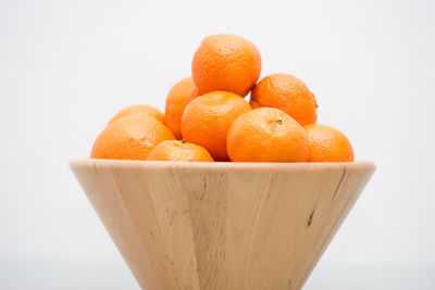 Close-up of orange fruit against white background