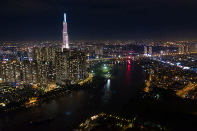 High angle view of city lit up at night