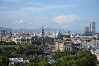 View of cityscape against cloudy sky