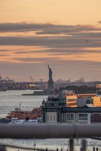 Statue in city during sunset