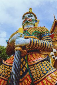 Low angle view of statue against temple building