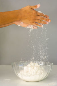 Close-up of person preparing food in bowl