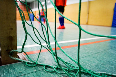 Low section of sportsperson seen through net