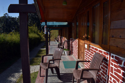 Empty chairs and table in restaurant by building