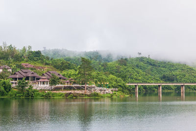 Bridge over river with houses in background