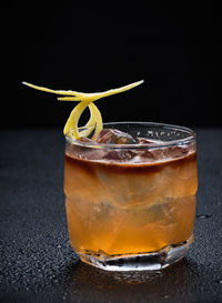 Close-up of beer glass against black background