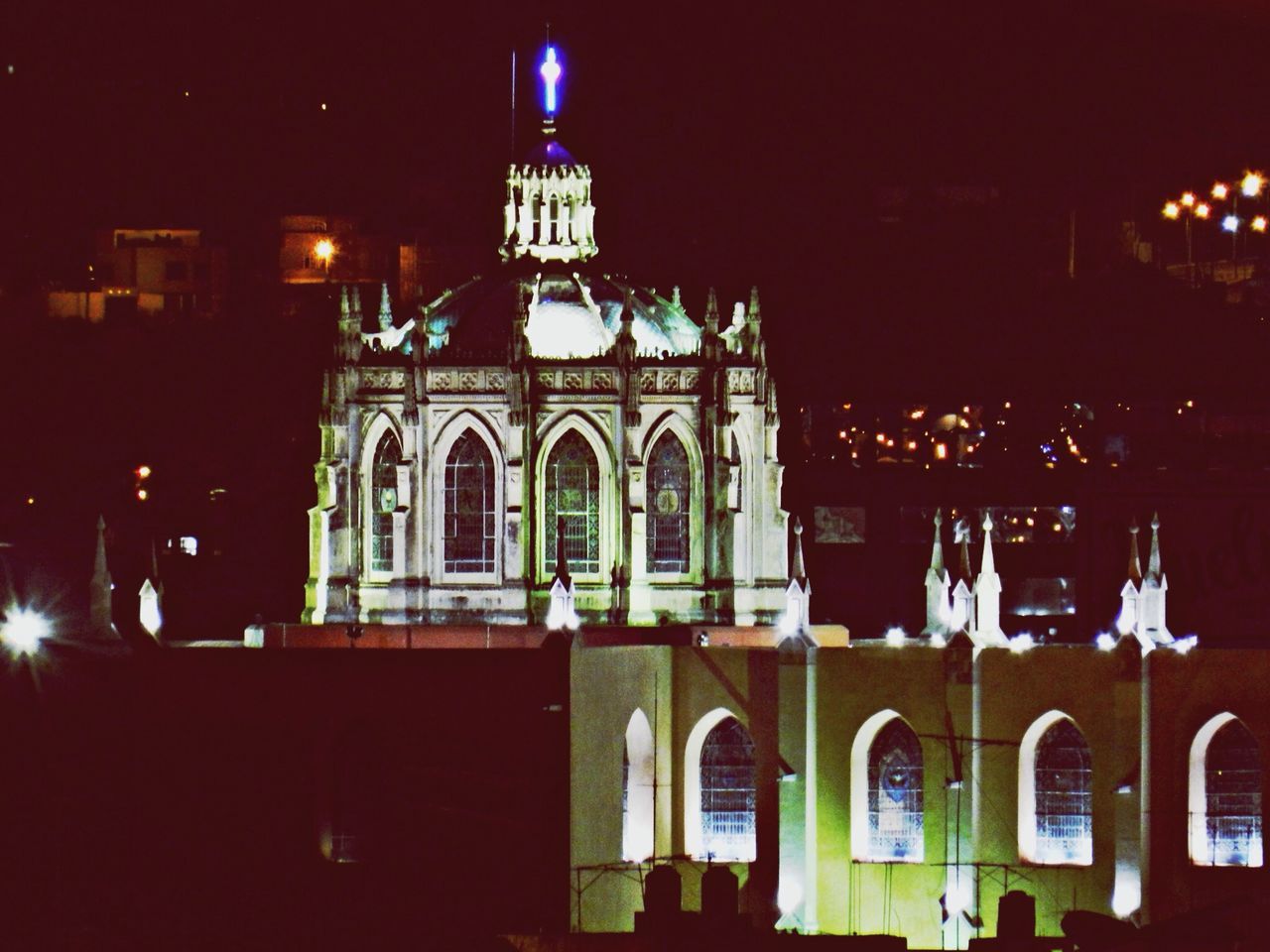 building exterior, architecture, built structure, illuminated, night, religion, place of worship, church, spirituality, low angle view, cathedral, facade, dome, lighting equipment, arch, street light, outdoors, city