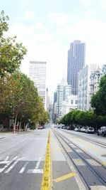 Road by city against sky